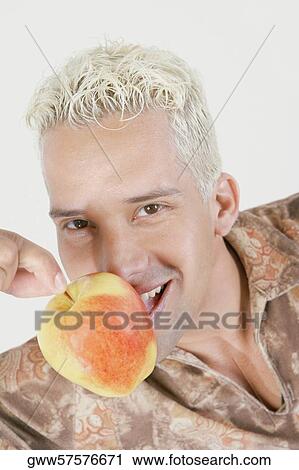 Close-up of a young man holding an apple View Large Photo Image Stock Image - Close-up of a young man holding an apple. Fotosearch