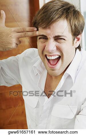 Close-up of a young man making a gun sign View Large Photo Image Stock Image - Close-up of a young man making a gun sign. Fotosearch