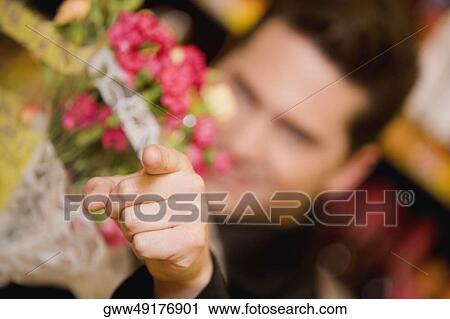 Close-up of a young man pointing forward View Large Photo Image Stock Image - Close-up of a young man pointing forward. Fotosearch