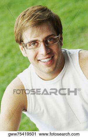 Close-up of a young man smiling View Large Photo Image Stock Image - Close-up of a young man smiling. Fotosearch