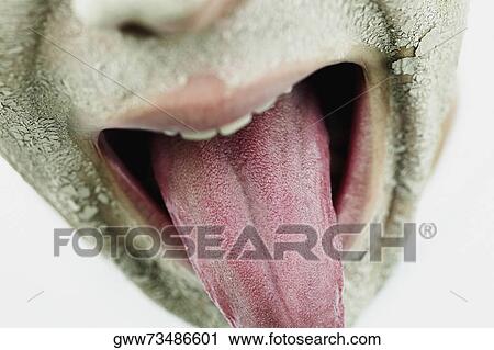 Close-up of a young man sticking his tongue out View Large Photo Image Stock Image - Close-up of a young man sticking his tongue out. Fotosearch