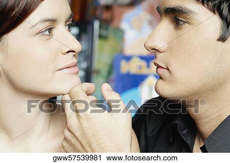 Close-up of a young man touching a young woman's chin View Large Photo Image Stock Image - Close-up of a young man touching a young woman's chin. Fotosearch