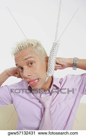 Stock Image - Close-up of a young man with a noose around his neck. Fotosearch
