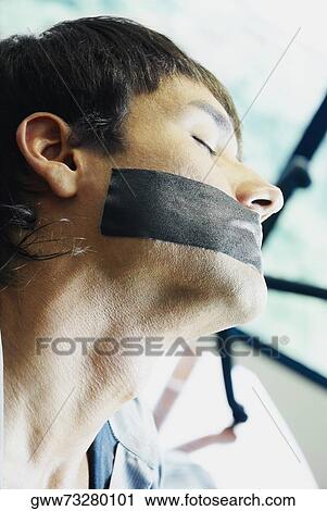 Close-up of a young man with adhesive tape over his moth View Large Photo Image Stock Image - Close-up of a young man with adhesive tape over his moth. Fotosearch