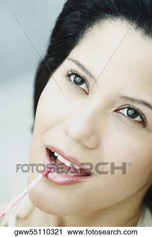Close-up of a young woman applying lip liner View Large Photo Image Stock Image - Close-up of a young woman applying lip liner. Fotosearch