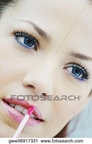 Close-up of a young woman applying lip liner View Large Photo Image Stock Image - Close-up of a young woman applying lip liner. Fotosearch
