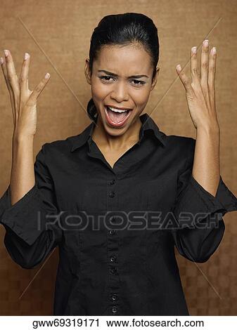 Close-up of a young woman gesturing View Large Photo Image Stock Image - Close-up of a young woman gesturing. Fotosearch