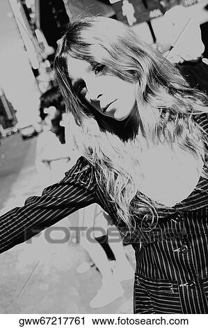 Close-up of a young woman hailing a taxi View Large Photo Image Stock Image - Close-up of a young woman hailing a taxi. Fotosearch