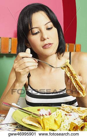 Close-up of a young woman holding a wrap sandwich View Large Photo Image Stock Image - Close-up of a young woman holding a wrap sandwich. Fotosearch