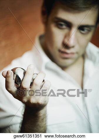 Close-up of a young woman holding two metal balls View Large Photo Image Stock Image - Close-up of a young woman holding two metal balls. Fotosearch