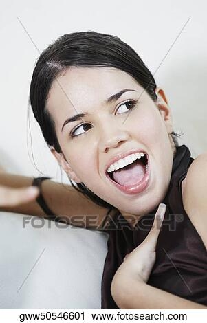 Stock Image - Close-up of a young woman looking surprised. Fotosearch