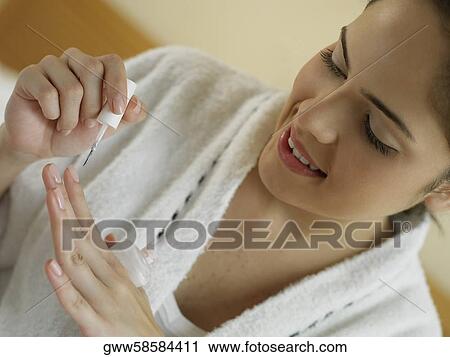 Close-up of a young woman polishing her nails View Large Photo Image Stock Image - Close-up of a young woman polishing her nails. Fotosearch