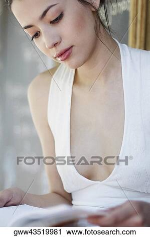 Close-up of a young woman reading a book View Large Photo Image Stock Image - Close-up of a young woman reading a book. Fotosearch