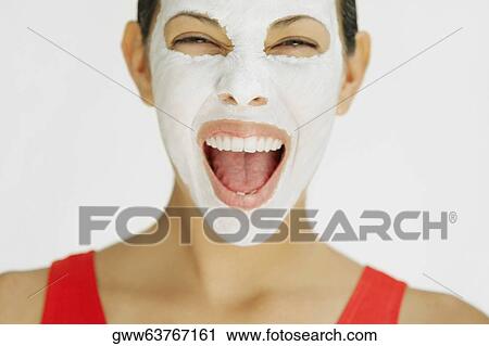 Close-up of a young woman shouting with facial mask on her face View Large Photo Image Stock Image - Close-up of a young woman shouting with facial mask on her face. Fotosearch