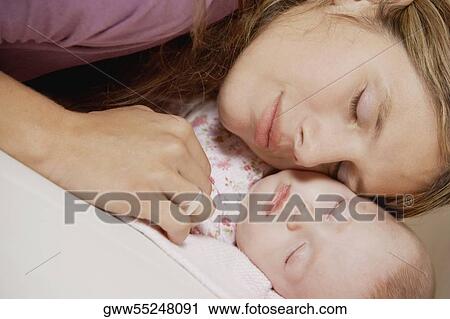 Close-up of a young woman sleeping with her daughter View Large Photo Image Stock Image - Close-up of a young woman sleeping with her daughter. Fotosearch