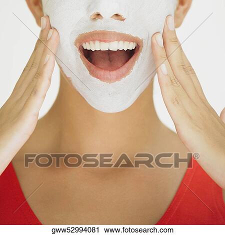 Close-up of a young woman smiling with a facial mask on her face View Large Photo Image Stock Image - Close-up of a young woman smiling with a facial mask on her face. Fotosearch