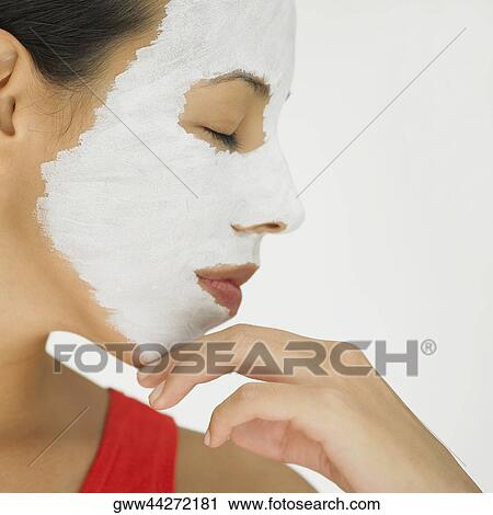 Close-up of a young woman wearing a facial mask with her eyes closed  View Large Photo Image Stock Image - Close-up of a young woman wearing a facial mask with her eyes closed . Fotosearch