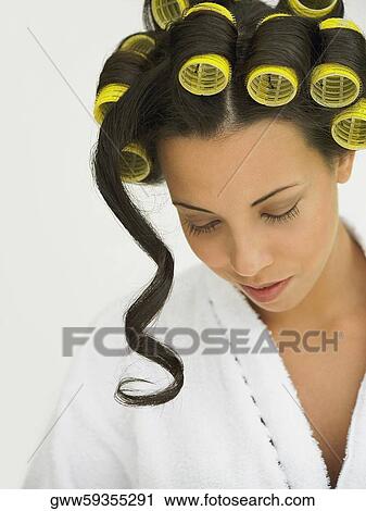 Close-up of a young woman with curlers in her hair View Large Photo Image Stock Image - Close-up of a young woman with curlers in her hair. Fotosearch