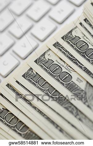 Close-up of American dollar bills on a laptop View Large Photo Image Stock Image - Close-up of American dollar bills on a laptop. Fotosearch