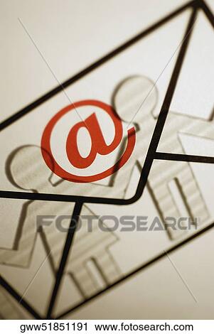 Close-up of an 'at' symbol with envelope symbol on paper chain dolls View Large Photo Image Stock Image - Close-up of an 'at' symbol with envelope symbol on paper chain dolls. Fotosearch