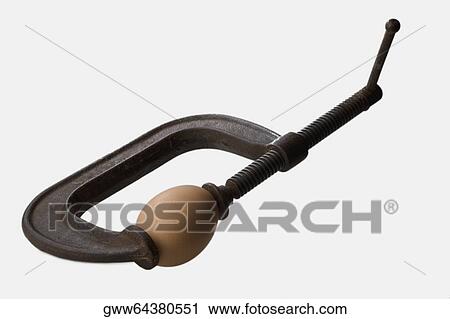 Stock Image - Close-up of an egg in a clamp. Fotosearch