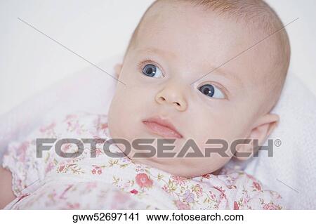 Close-up of baby girl looking sideways View Large Photo Image Stock Image - Close-up of baby girl looking sideways. Fotosearch