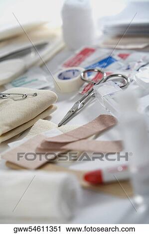 Close-up of bandages and medical tape with a pair of scissors View Large Photo Image Stock Image - Close-up of bandages and medical tape with a pair of scissors. Fotosearch