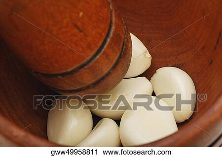 Close-up of cloves of garlic in a mortar View Large Photo Image Stock Image - Close-up of cloves of garlic in a mortar. Fotosearch