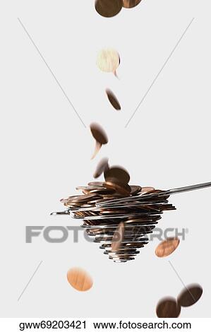 Close-up of coins falling in a wire whisk View Large Photo Image Stock Image - Close-up of coins falling in a wire whisk. Fotosearch
