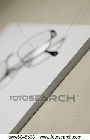 Close-up of eyeglasses and a notepad on the table View Large Photo Image Stock Image - Close-up of eyeglasses and a notepad on the table. Fotosearch