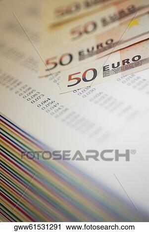 Close-up of fifty Euro bank notes on a stack of financial reports View Large Photo Image Stock Image - Close-up of fifty Euro bank notes on a stack of financial reports. Fotosearch