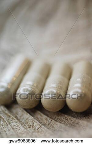 Close-up of four capsules View Large Photo Image Stock Image - Close-up of four capsules. Fotosearch