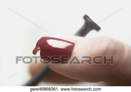 Close-up of human fingers holding a nail View Large Photo Image Stock Image - Close-up of human fingers holding a nail. Fotosearch