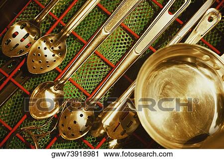Close-up of kitchen utensils hanging in a domestic kitchen View Large Photo Image Stock Image - Close-up of kitchen utensils hanging in a domestic kitchen. Fotosearch