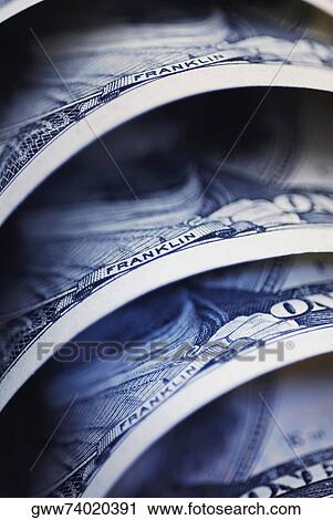 Stock Image - Close-up of one hundred dollar bills. Fotosearch