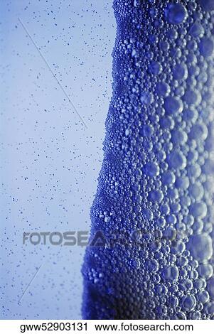 Close-up of particles floating on water View Large Photo Image Stock Image - Close-up of particles floating on water. Fotosearch