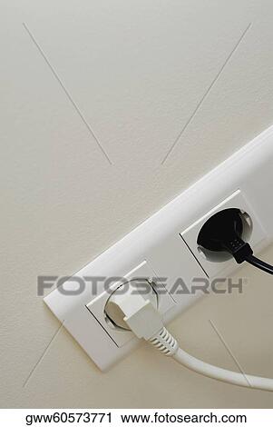 Stock Image - Close-up of plugs in power sockets. Fotosearch