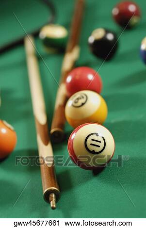 Close-up of pool balls and pool cues on a pool table View Large Photo Image Stock Image - Close-up of pool balls and pool cues on a pool table. Fotosearch
