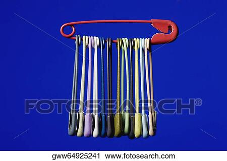 Stock Image - Close-up of safety pins hung in a safety pin. Fotosearch