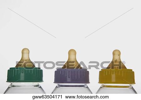 Close-up of three baby bottles in a row View Large Photo Image Stock Image - Close-up of three baby bottles in a row. Fotosearch