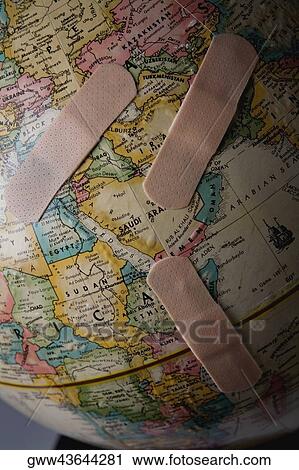 Close-up of three bandages on a globe View Large Photo Image Stock Image - Close-up of three bandages on a globe. Fotosearch