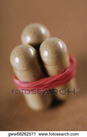 Close-up of three capsules tied with a rubber band View Large Photo Image Stock Image - Close-up of three capsules tied with a rubber band. Fotosearch