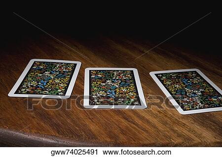 Close-up of three cards on a table View Large Photo Image Stock Image - Close-up of three cards on a table. Fotosearch