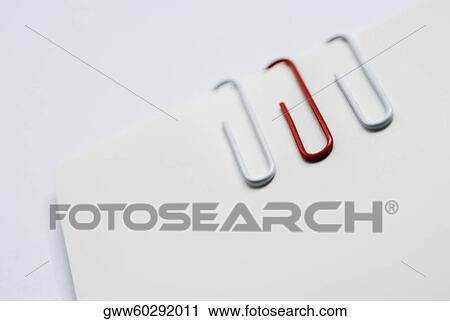 Close-up of three paper clips on a sheet of paper View Large Photo Image Stock Image - Close-up of three paper clips on a sheet of paper. Fotosearch