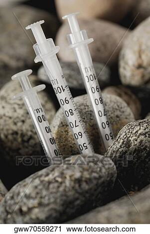 Close-up of three syringes with pebbles View Large Photo Image Stock Image - Close-up of three syringes with pebbles. Fotosearch