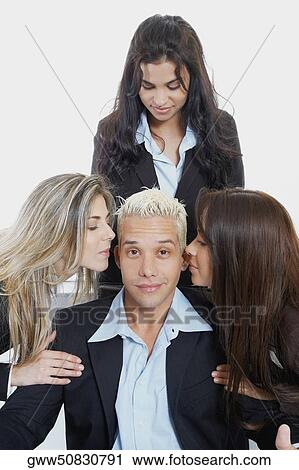 Close-up of two businesswomen whispering into a businessman's ear View Large Photo Image Stock Image - Close-up of two businesswomen whispering into a businessman's ear. Fotosearch