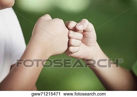 Close-up of two people with their fists touching View Large Photo Image Stock Image - Close-up of two people with their fists touching. Fotosearch