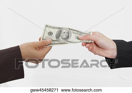 Close-up of two people's hands holding American paper currency View Large Photo Image Stock Image - Close-up of two people's hands holding American paper currency. Fotosearch