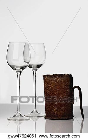 Close-up of two stem glasses with a mug View Large Photo Image Stock Image - Close-up of two stem glasses with a mug. Fotosearch