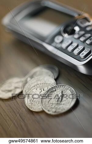 Close-up of US coins and a mobile phone on the table View Large Photo Image Stock Image - Close-up of US coins and a mobile phone on the table. Fotosearch
